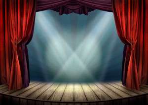 Theater stage with red curtains and spotlights